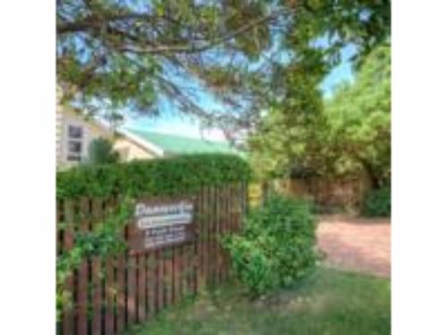 a sign on a fence in front of a house at Dunwerkin Self Catering in Kenton on Sea