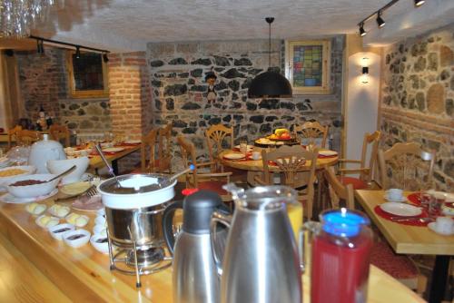 a kitchen with a table with tables and chairs at Hotel Vila Sigal Korce in Korçë