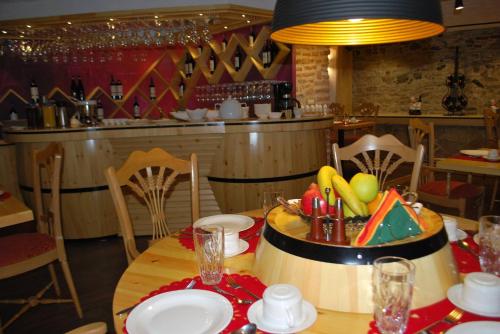 a dining room with a table with a bowl of food on it at Hotel Vila Sigal Korce in Korçë