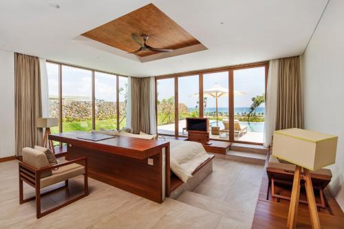 a bedroom with a desk and a bed with a desk at FLC Luxury Resort Quy Nhon in Quy Nhon