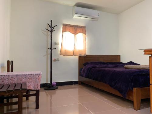 a bedroom with a bed and a lamp in it at Scarecrow Homestay in Jincheng