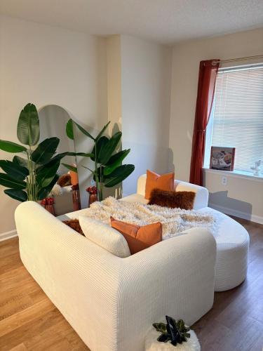 a living room with a couch and a bed at Luxury, Chic, Apt with Game Room, Movie Theatre, & 24hr Gym in Rockville