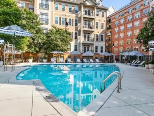 a swimming pool in front of a building at Luxury, Chic, Apt with Game Room, Movie Theatre, & 24hr Gym in Rockville