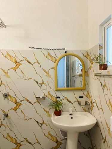 a bathroom with a sink and a mirror at Hasara Homestay in Dickwella