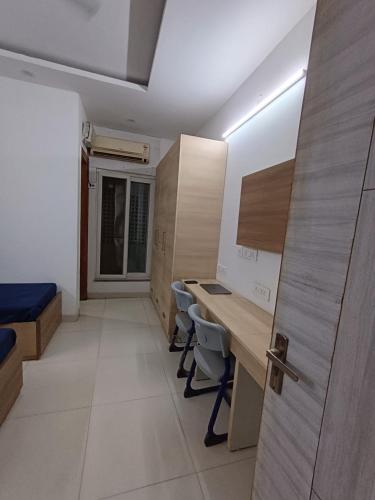 a room with a desk and chairs and a door at The Elite Ambience Hotel in Greater Noida