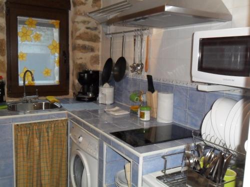 a kitchen with a sink and a stove top oven at Baelo Claudia in Navalguijo