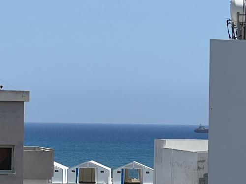 a view of the ocean from the roofs of white buildings at Sea view Appartment in Larnaca