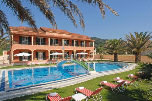 a resort with a swimming pool and a building at Dimitris Apartments in Sidari