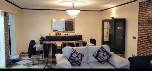 a living room with a couch and a table at Sheraton Apartment شقة الشيراتون in Cairo