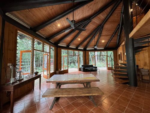 a living room with a table and a ceiling fan at Daintree Cascades in Cape Tribulation