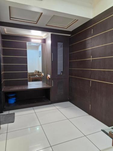 a bathroom with wooden walls and a mirror at Hotel Radiant Kolhapur in Kolhapur