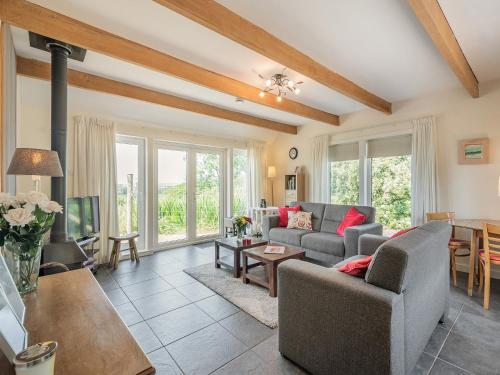 a living room with two couches and a table at Strathmaddie Farm Cottage in Palnure