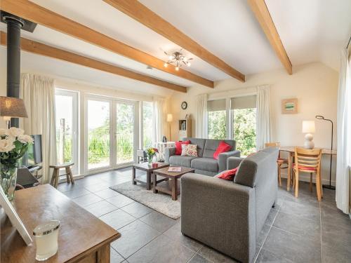 a living room with a couch and a table at Strathmaddie Farm Cottage in Palnure