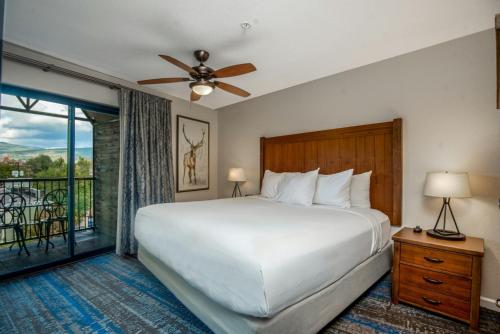 a bedroom with a large white bed and a window at Club Wyndham Durango in Durango