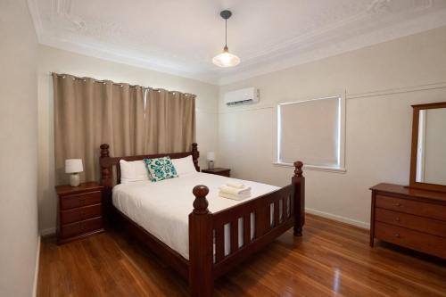 a bedroom with a large bed and a window at Entire House walk to South Bank mater in Brisbane