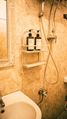 a bathroom with a shower and a toilet and a sink at Umah Bukit House in Uluwatu