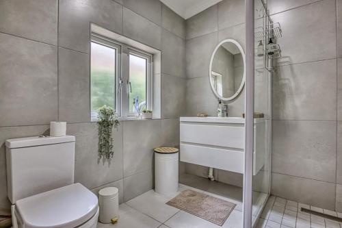 a bathroom with a toilet and a sink and a mirror at French Bistro Studio in Johannesburg