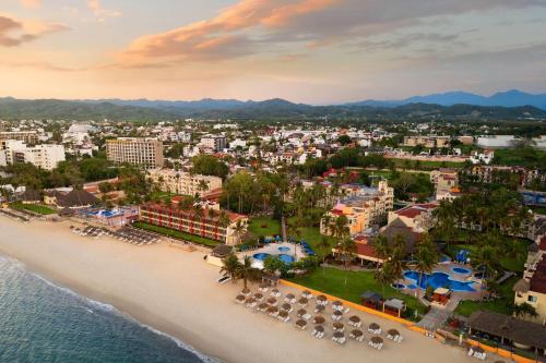 an aerial view of a beach in a resort at Grand Decameron Complex Bucerias, A Trademark All-Inclusive Resort in Bucerías