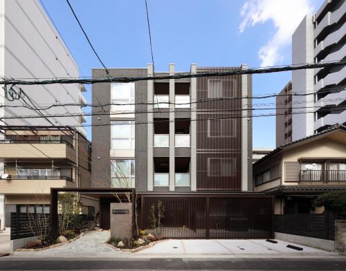an apartment building in a city with power lines at GRACE STAY Hiroshima Peace Memorial Park in Hiroshima