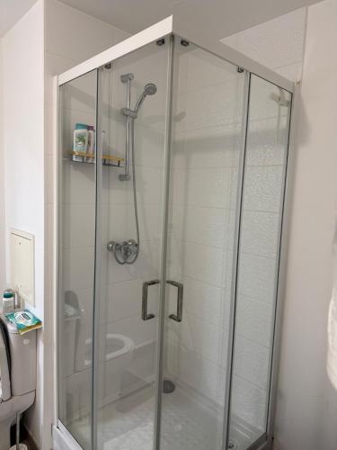 a shower with a glass door in a bathroom at Bright and cozy studio entre Paris et Disneyland in Champs-sur-Marne