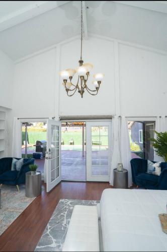 a living room with a bed and a chandelier at silver in Chatsworth