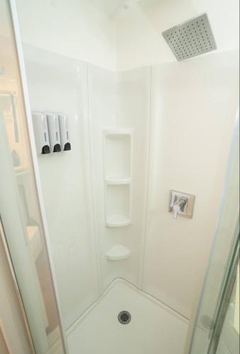 a bathroom with a shower with a glass door at silver in Chatsworth