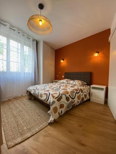 a bedroom with a bed and a large window at Le Cocon de Langes in Orange