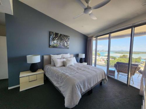 a bedroom with a bed with a view of the ocean at The Dunes Cotton Tree in Maroochydore