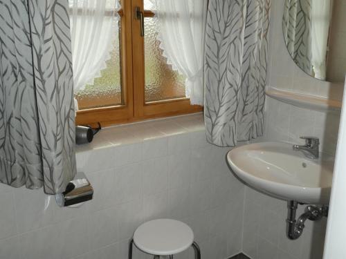 a bathroom with a sink and a window at Gästehaus Bergblick in Wallgau