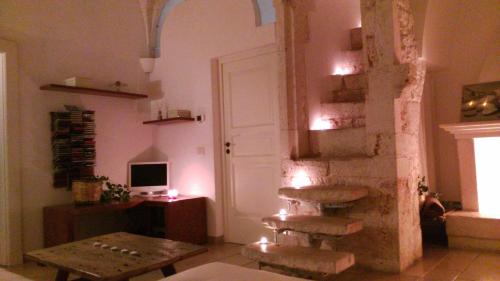 a living room with a ladder and a table and a door at Via Roma in Ostuni