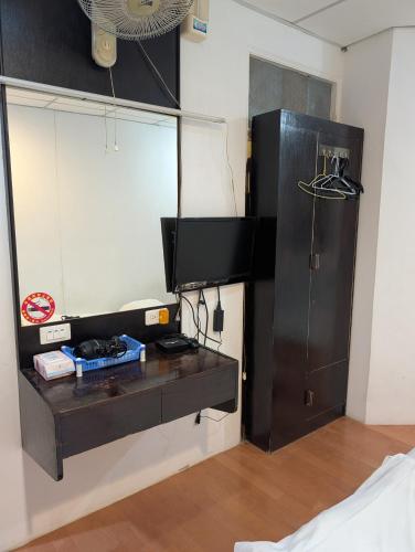 a room with a table and a black cabinet at Golden Dragon Hotel in Houlong