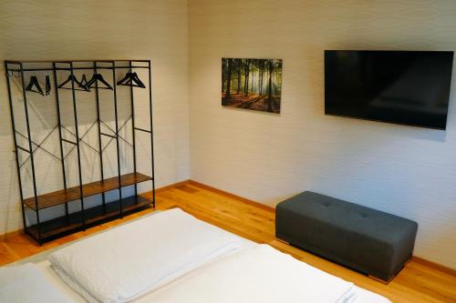 a living room with a flat screen tv on the wall at Ferienhaus DONAUzeit in Sigmaringen