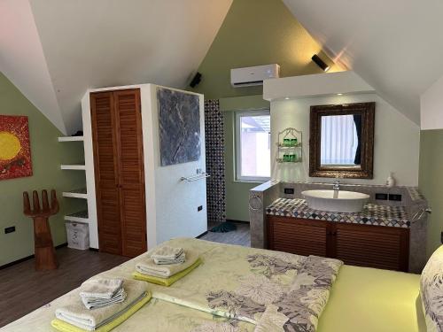 a large bathroom with a sink and a large bed at Laguna Beach House in Ko Chang