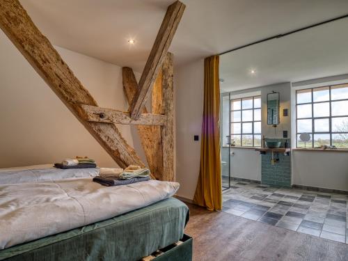 a bedroom with a bed and a bathroom at Country Lodge - Heuboden in Tating