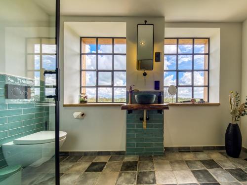 a bathroom with a sink and a glass shower at Country Lodge - Heuboden in Tating