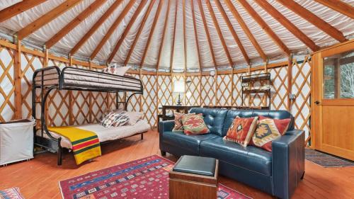 a living room with a couch and a bed in a yurt at Yurt 1 - The Prospector in Idaho City