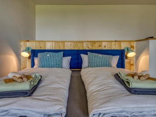 two beds with pillows on them in a bedroom at Country Lodge - Stall in Tating