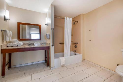 a bathroom with a tub shower and a sink at Comfort Suites Elizabethtown in Elizabethtown