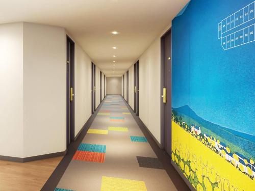 a hallway with a painting on the wall at Comfort Hotel Niigata in Niigata
