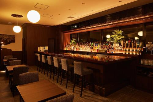 a bar in a restaurant with a lot of drinks at hotel around TAKAYAMA, an Ascend Collection Hotel in Takayama