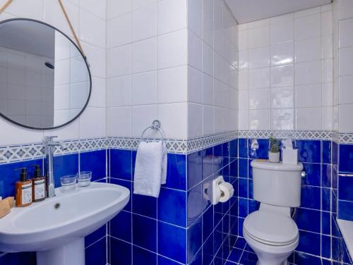a blue and white bathroom with a toilet and a sink at Greek Village - Latchi הכפר היווני - כשר in Polis Chrysochous