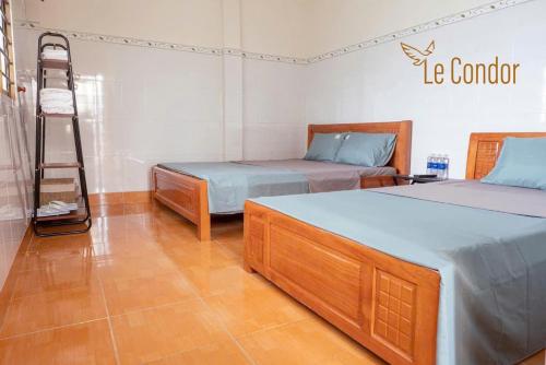 a room with two beds and a ladder in it at Le Condor House and Café in Con Dao