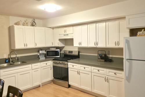 a kitchen with white cabinets and a white refrigerator at Los Angeles Retreat Close to Hotspots in Los Angeles