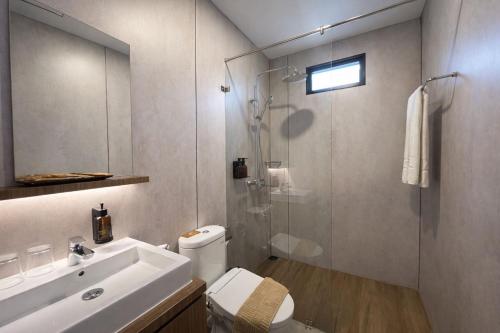 a bathroom with a shower and a toilet and a sink at The Glamping at ARTOTEL Pelangi Park in Pasirkuda