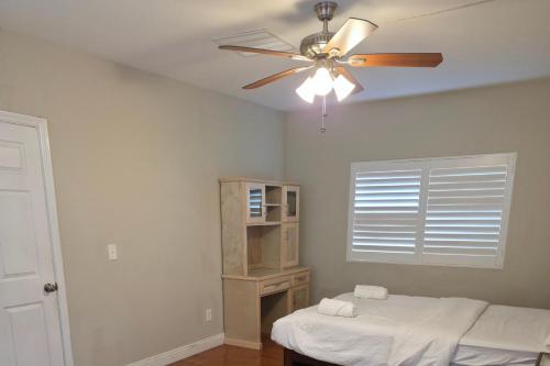 a room with two beds and a ceiling fan at Los Angeles Retreat Close to Hotspots in Los Angeles