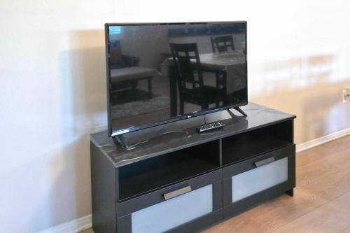 a black entertainment center with a flat screen tv at Los Angeles Retreat Close to Hotspots in Los Angeles