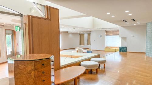 a living room with a couch and a table at Livemax Resort Yatsugatake Kogen in Hokuto