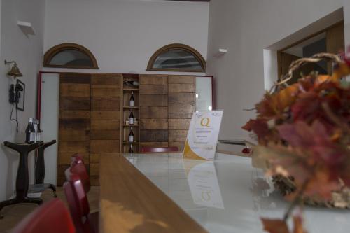 a table with a sign on it in a room at Palazzo Tronconi agriturismo in Arce