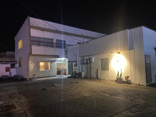 a building with a light on the side of it at night at HOTEL Saboten Apartment in Miyoshi