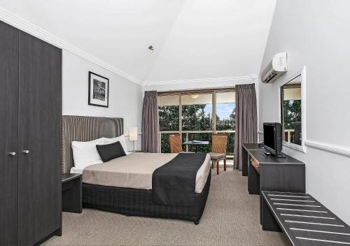 a hotel room with a bed and a television at Comfort Inn & Apartments Northgate Airport in Brisbane